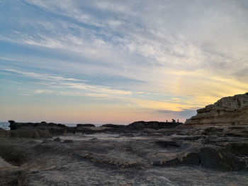 Scenic view of beach against sky during sunset