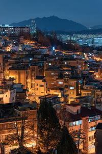 High angle view of illuminated buildings in city at night