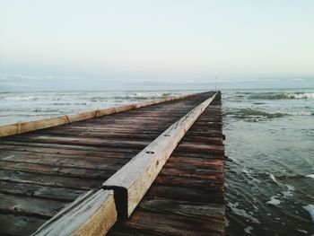 Pier over sea against clear sky