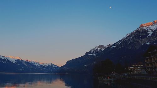 Scenic view of lake and mountains against clear sky