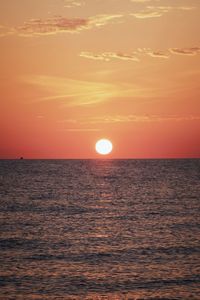 Scenic view of sea against orange sky