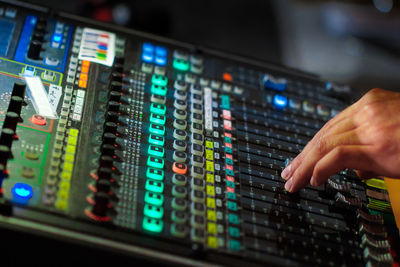 Cropped image of dj working on sound mixer