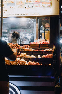 Man standing in store for sale at market