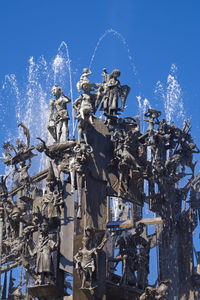 Low angle view of statue against blue sky