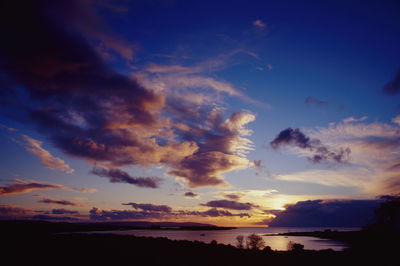 Scenic view of dramatic sky over sea during sunset