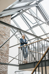 Confident businesswoman with long grey hair in a loft