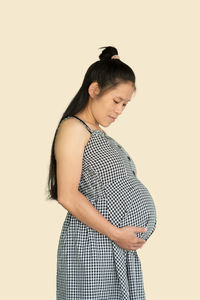 Young woman standing against white background