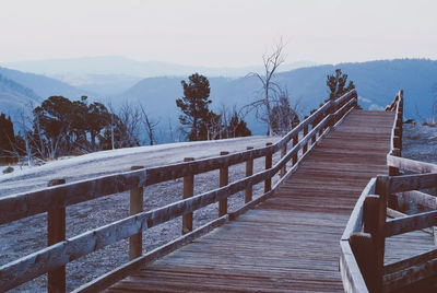 Wooden jetty on snow covered landscape