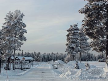 Snow covered field against sky