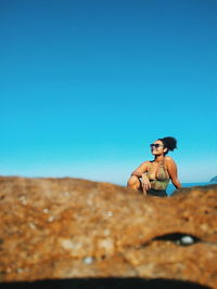 Portrait of young woman on rock