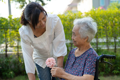 Caregiver daughter hug and help asian senior or elderly old lady woman  