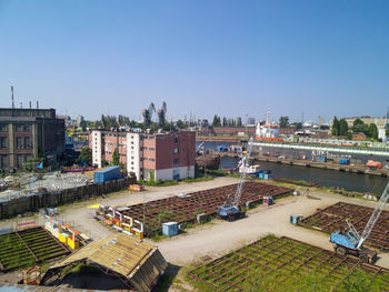 High angle view of buildings against clear blue sky