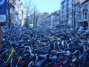 Bicycles parked in city against clear sky