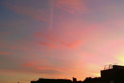 Low angle view of building against sky at sunset