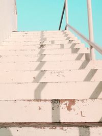 Low angle view of white wall against blue sky