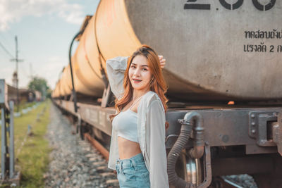 Portrait of smiling young woman standing outdoors