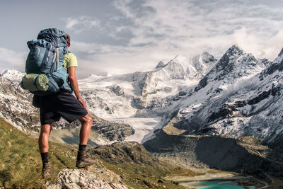 Rear view of man standing on mountain