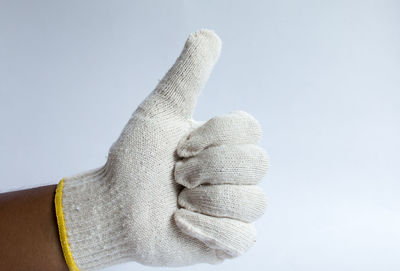 Close-up of hand against white background