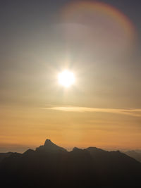 Scenic view of silhouette mountains against sky during sunset