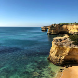 Scenic view of sea against clear blue sky