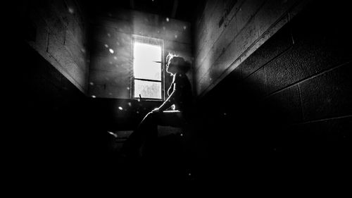 Man in illuminated building at night