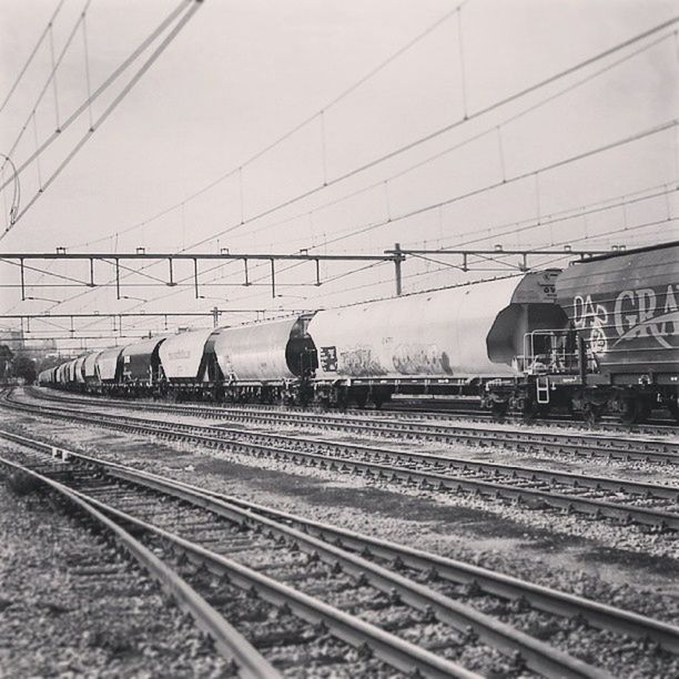 railroad track, rail transportation, public transportation, transportation, railroad station platform, railroad station, train - vehicle, railway track, power line, passenger train, travel, train, mode of transport, public transport, sky, electricity pylon, day, cable, journey, power supply