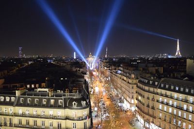 Distance view of illuminated eiffel tower with cityscape at night