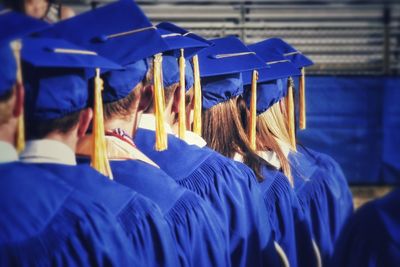Rear view of students standing in row