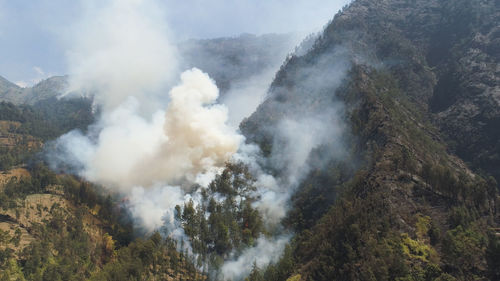 Fire in mountain forest. aerial view forest fire and smoke on slopes hills. 