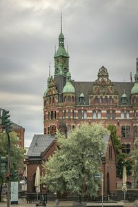 View of buildings against cloudy sky