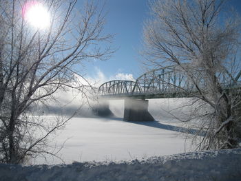 Bridge over river during winter