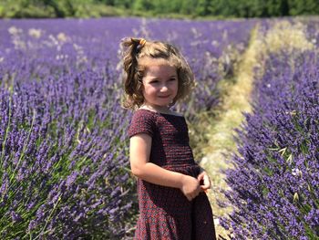 Smiling girl standing on lavender field