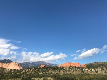 Scenic view of landscape against blue sky