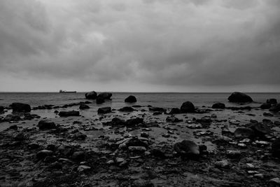 Rocks on beach against sky