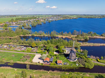 High angle view of townscape by sea against sky