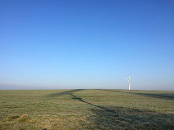 Windmill on field against sky