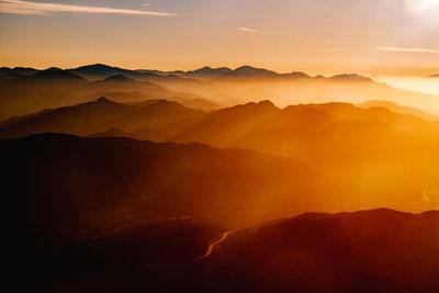 Scenic view of silhouette mountains against sky at sunset