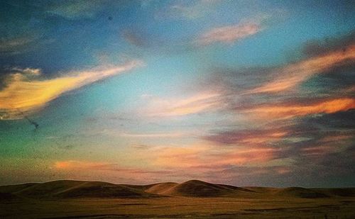 Scenic view of landscape against cloudy sky