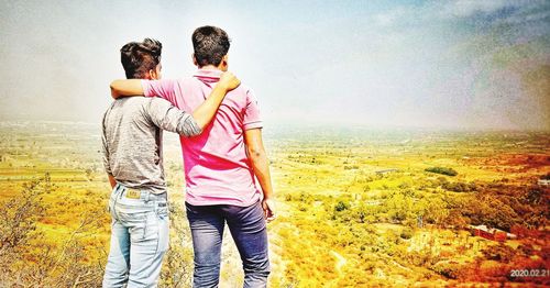 Friends standing in front of sea