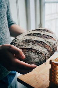 Close-up of man hand holding bread