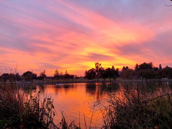 Scenic view of lake against romantic sky at sunset