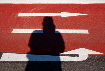 Shadow of person on road