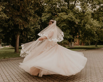 Low section of woman standing in park