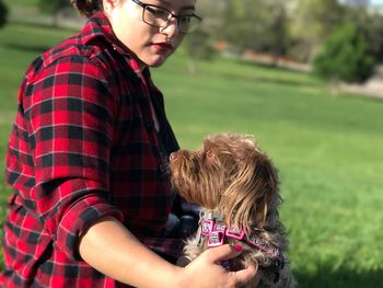 Close-up of woman embracing dog