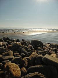 Rocks on beach against sky