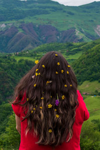 Rear view of woman standing on mountain