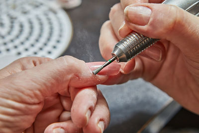 Cropped hand of person repairing car