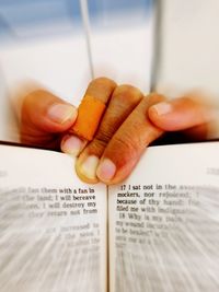 Close-up of hand holding book