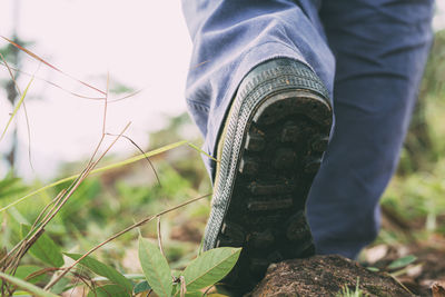 Low section of man standing on field