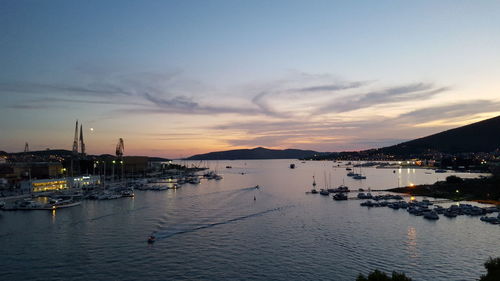 Boats in harbor at sunset